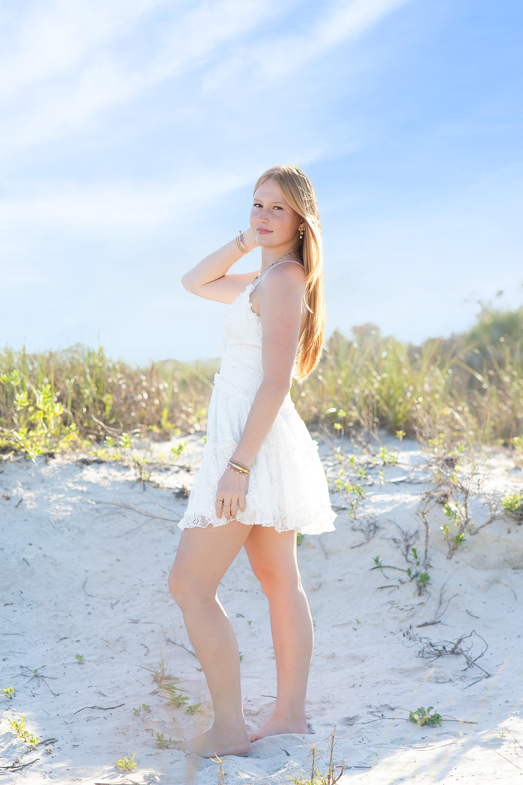 Senior girl wearing a white dress during a Jetty Park senior photography session in Cape Canaveral, Florida.