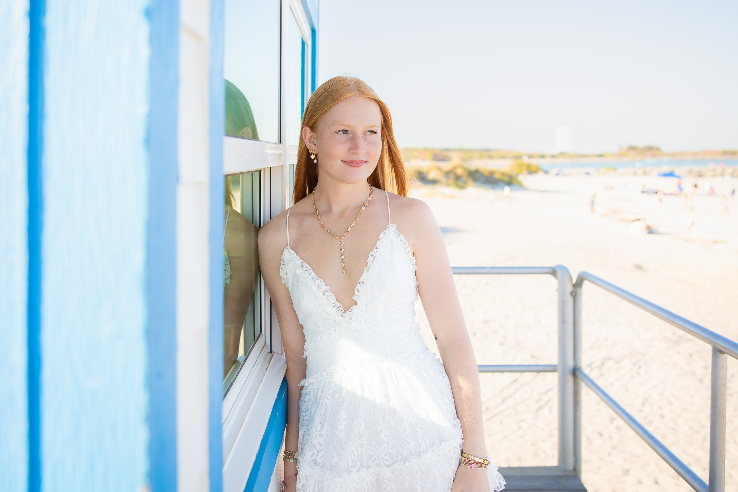 Senior girl posing at the colorful lifeguard stand at Jetty Park.